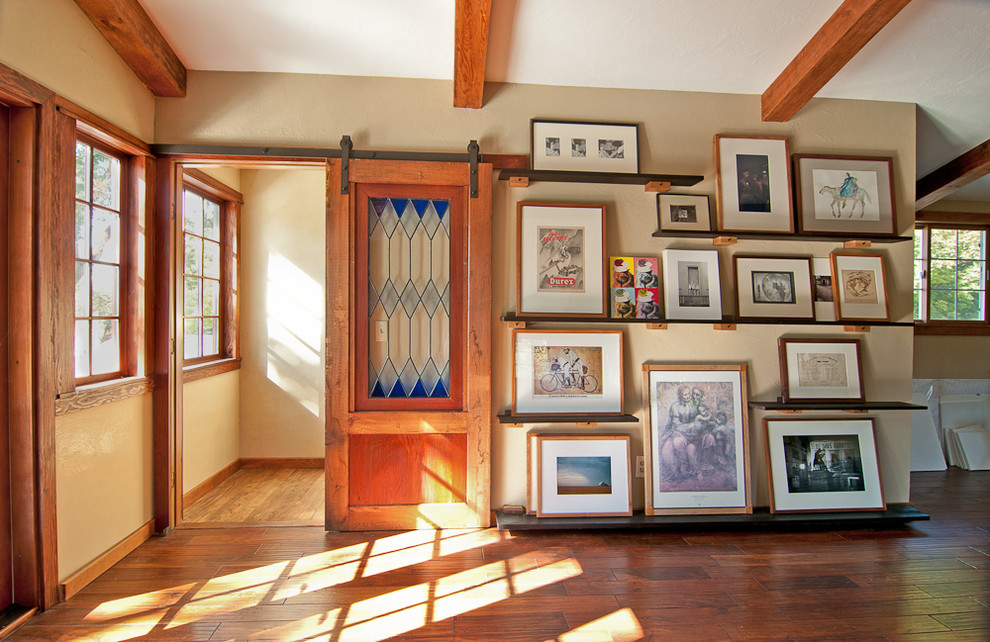 This is an example of a traditional home office in Portland with beige walls and medium hardwood floors.