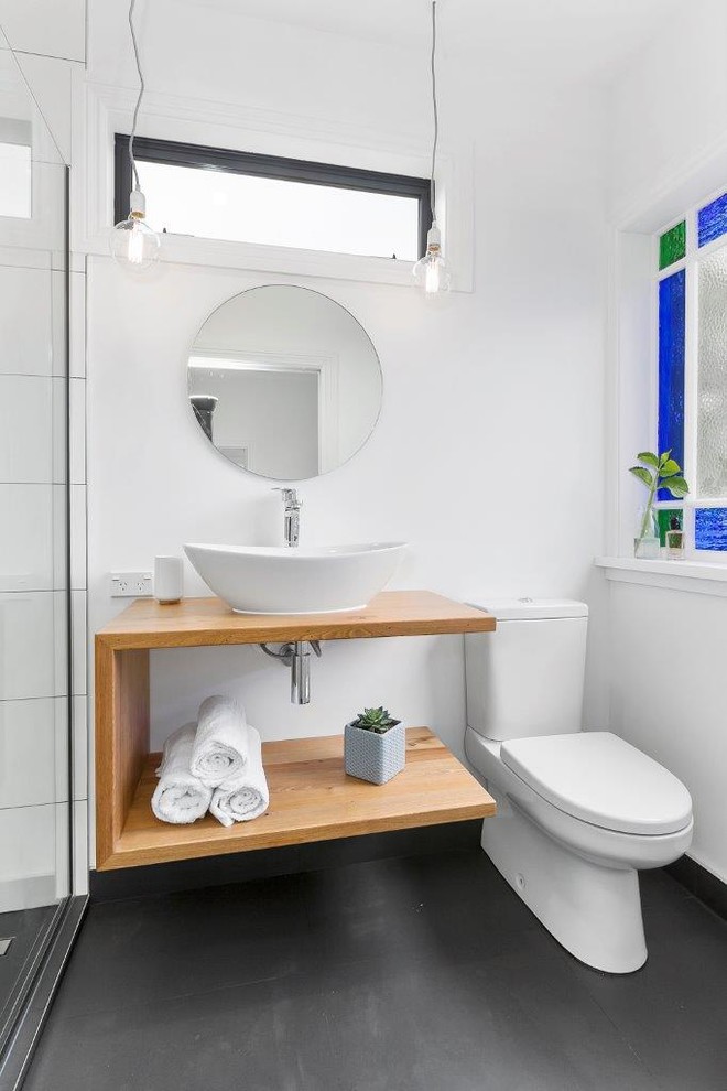 Inspiration for a small scandinavian bathroom in Other with medium wood cabinets, a double shower, white tile, ceramic tile, white walls, ceramic floors, a vessel sink, wood benchtops, grey floor and a hinged shower door.