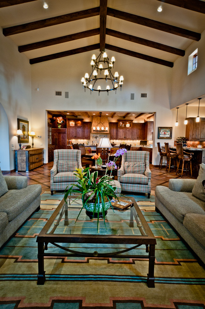 Inspiration for a mediterranean open concept family room in Austin with beige walls and carpet.
