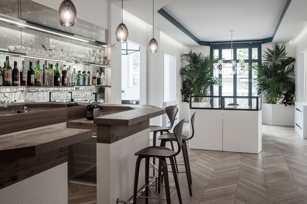 Photo of an expansive contemporary single-wall home bar in Paris with wood benchtops and brown benchtop.