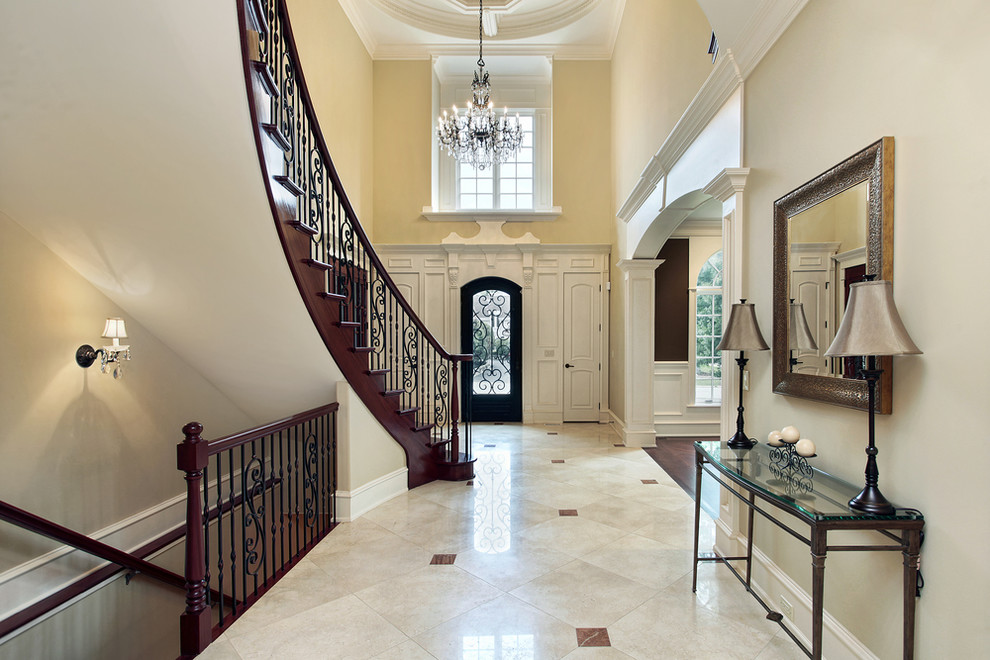 This is an example of a large traditional hallway in New York with beige walls and marble floors.