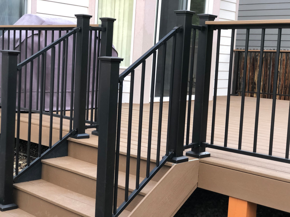 Inspiration for a large backyard ground level metal railing deck remodel in Denver with no cover