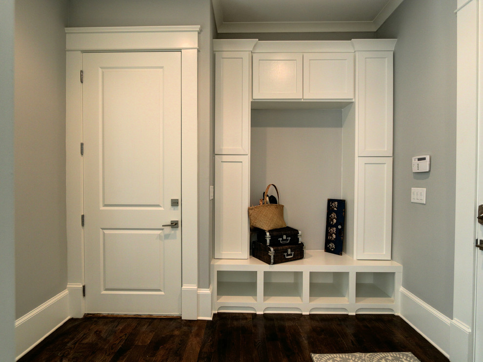 This is an example of a mid-sized transitional mudroom in Atlanta with grey walls, medium hardwood floors, a single front door and a white front door.