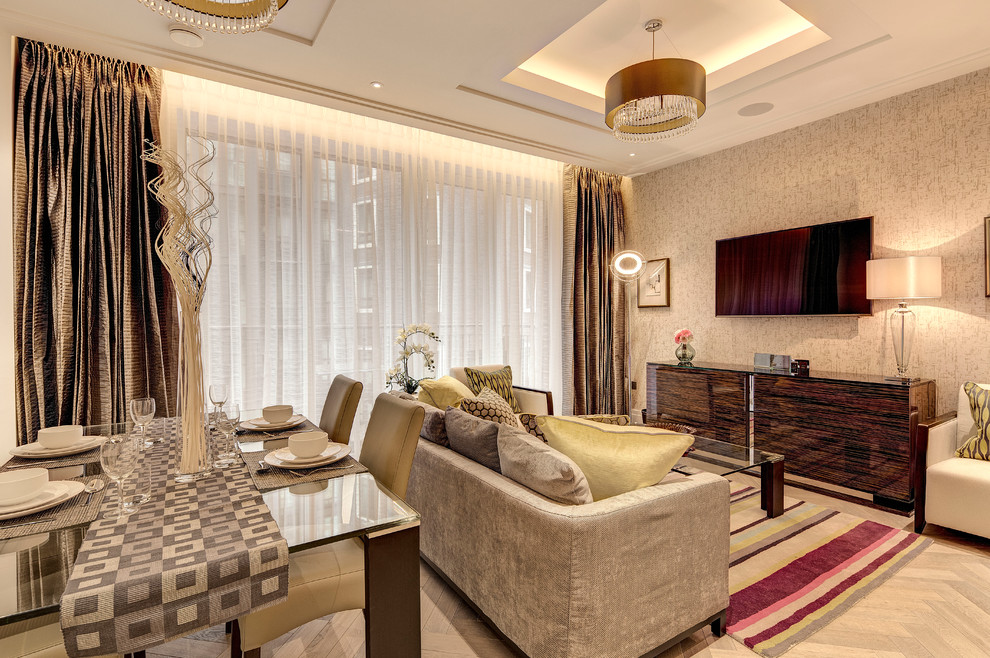 This is an example of a medium sized classic open plan dining room in London with multi-coloured walls, light hardwood flooring and no fireplace.