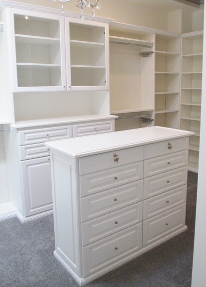 Inspiration for a large traditional gender-neutral walk-in wardrobe in Los Angeles with raised-panel cabinets, white cabinets, carpet and grey floor.