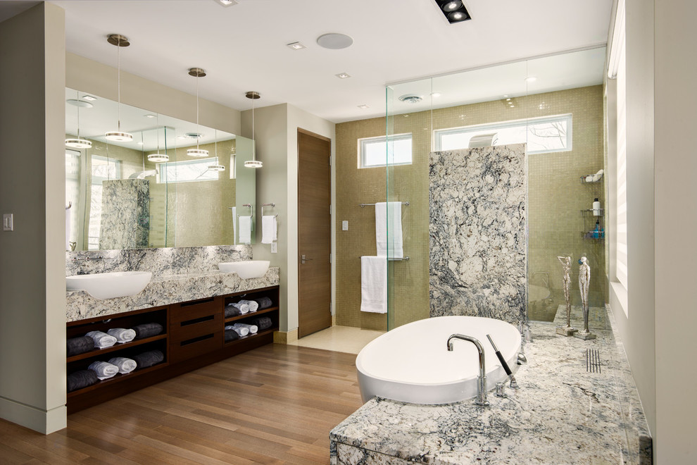 Design ideas for a contemporary master bathroom in Ottawa with a vessel sink, open cabinets, dark wood cabinets, a freestanding tub, an open shower, beige tile, beige walls, medium hardwood floors and an open shower.