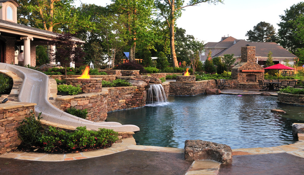 Design ideas for a traditional backyard custom-shaped pool in Nashville with a water slide.