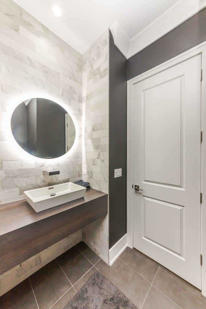 Powder room - large powder room idea in Chicago with brown cabinets, quartzite countertops and a floating vanity