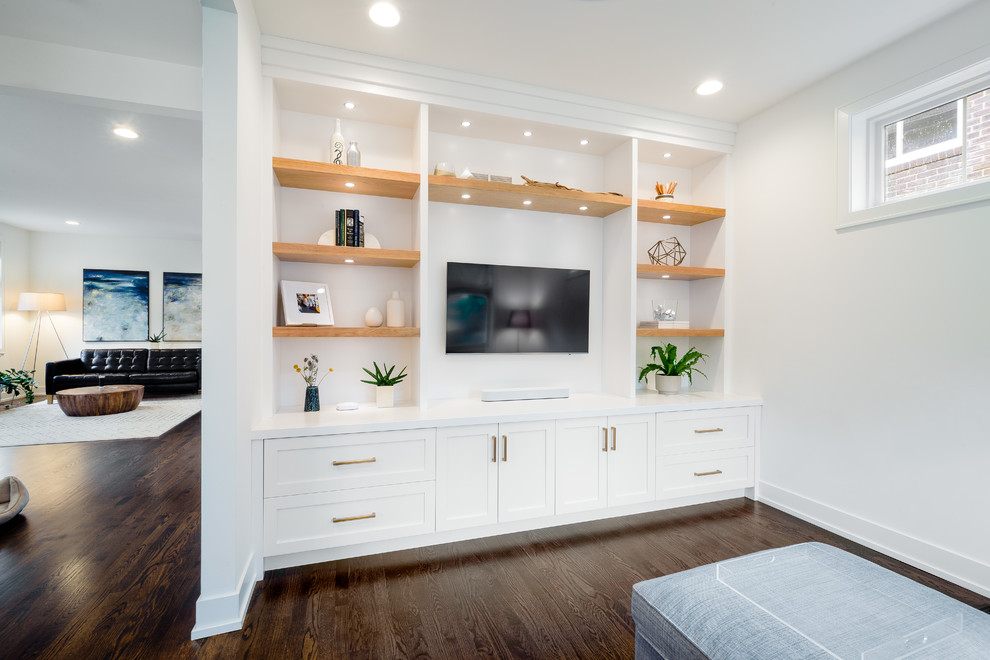 Inspiration for a transitional dark wood floor and brown floor family room remodel in Detroit with white walls, a media wall and no fireplace