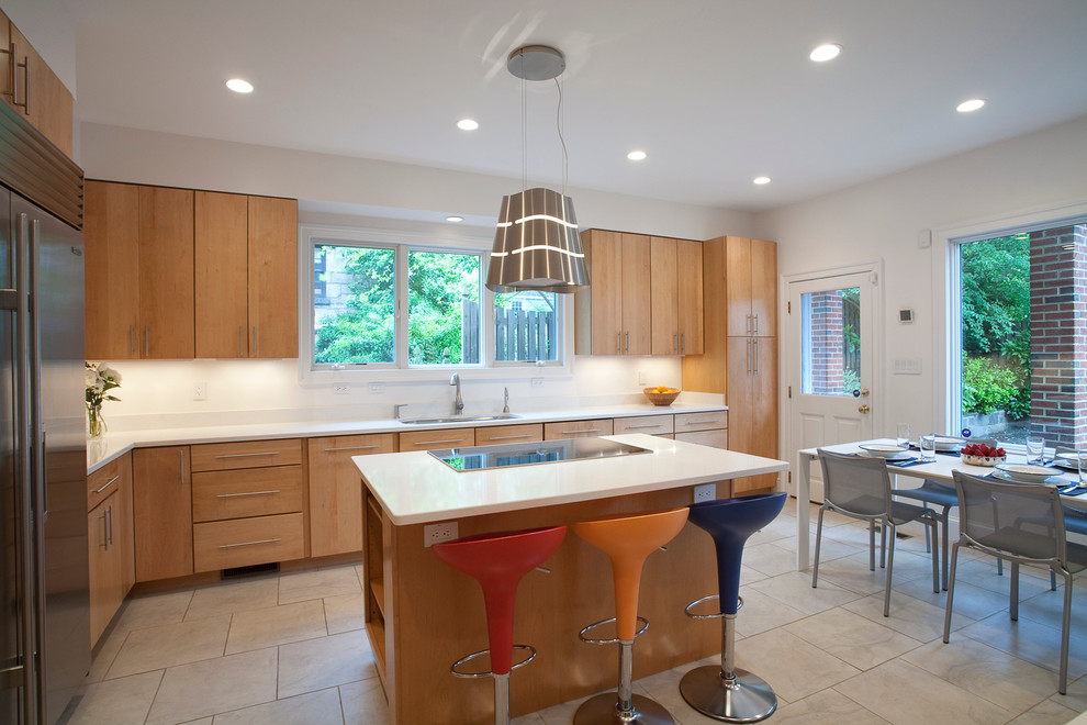 Modern eat-in kitchen in DC Metro with flat-panel cabinets and light wood cabinets.