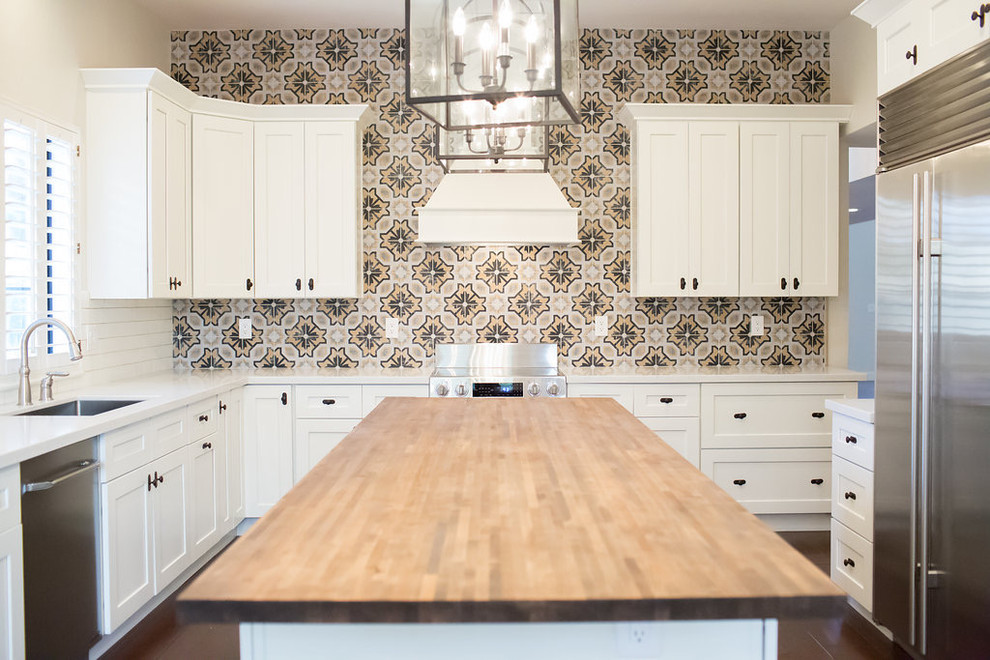 Mid-sized transitional u-shaped dark wood floor enclosed kitchen photo in Phoenix with an undermount sink, shaker cabinets, white cabinets, quartz countertops, multicolored backsplash, porcelain backsplash, stainless steel appliances and an island