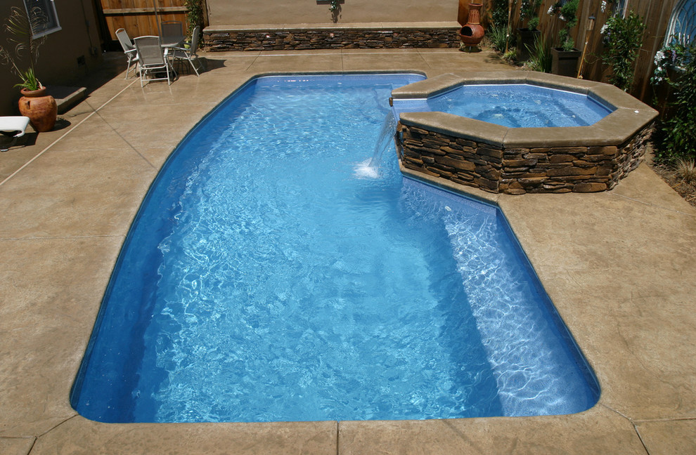 Inspiration for a mid-sized backyard stamped concrete and rectangular natural hot tub remodel in Cincinnati