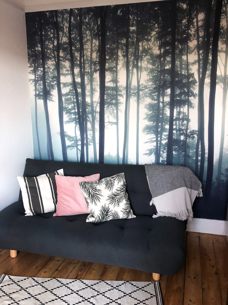 Small scandi home studio in Other with multi-coloured walls, medium hardwood flooring, a standard fireplace, a metal fireplace surround, a freestanding desk, brown floors and wallpapered walls.