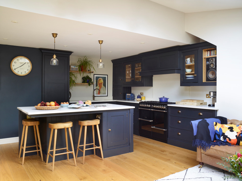 Design ideas for a modern open plan kitchen in Devon with shaker cabinets and with island.