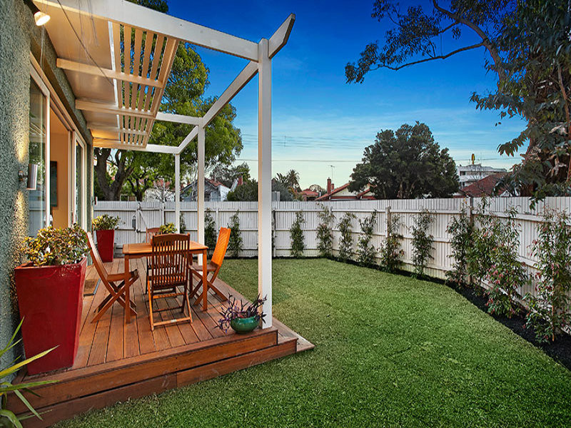 This is an example of a small contemporary front yard patio in Melbourne with decking and a pergola.