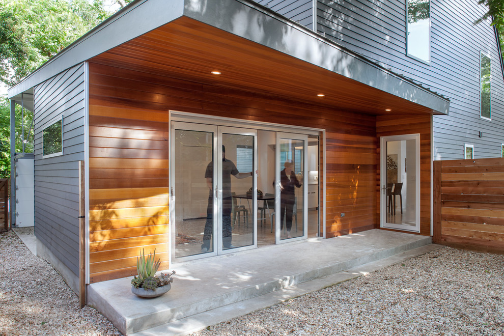 Photo of a small contemporary two-storey grey exterior in Austin with concrete fiberboard siding.