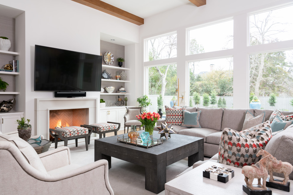 Design ideas for a transitional family room with white walls, a standard fireplace, a wall-mounted tv and exposed beam.