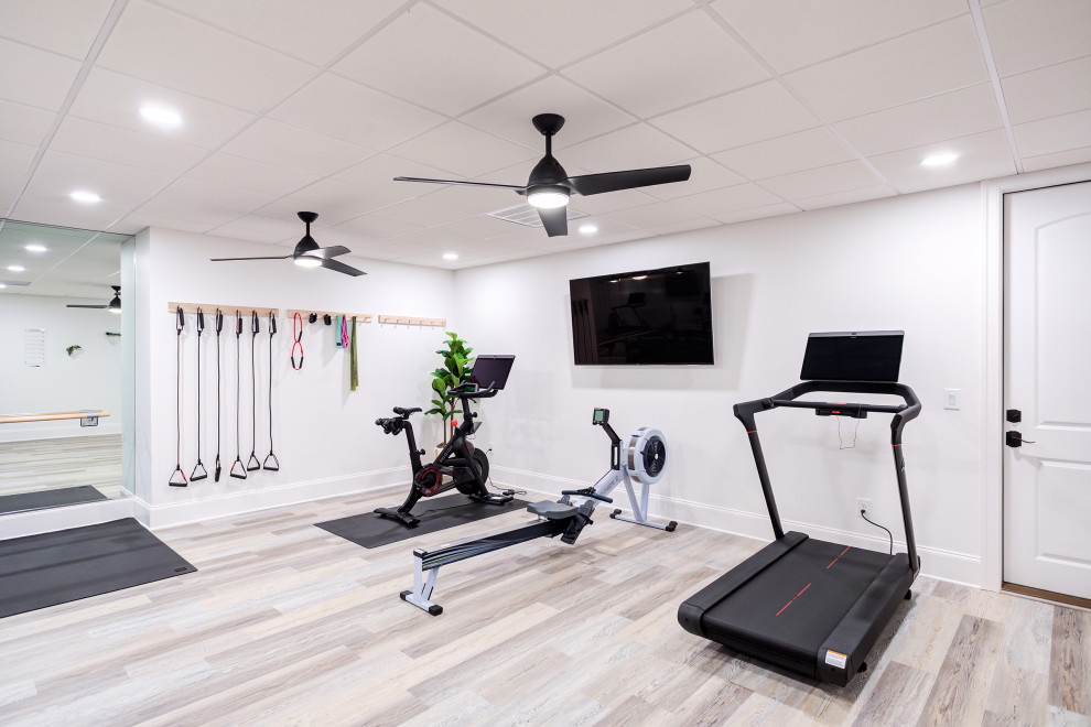 Inspiration for a mid-sized contemporary multipurpose gym in Raleigh with white walls, vinyl floors and grey floor.