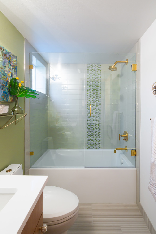 Inspiration for a mid-sized midcentury master bathroom in Seattle with flat-panel cabinets, light wood cabinets, a drop-in tub, a corner shower, a bidet, blue tile, glass tile, white walls, light hardwood floors, a wall-mount sink, quartzite benchtops, white floor and a hinged shower door.