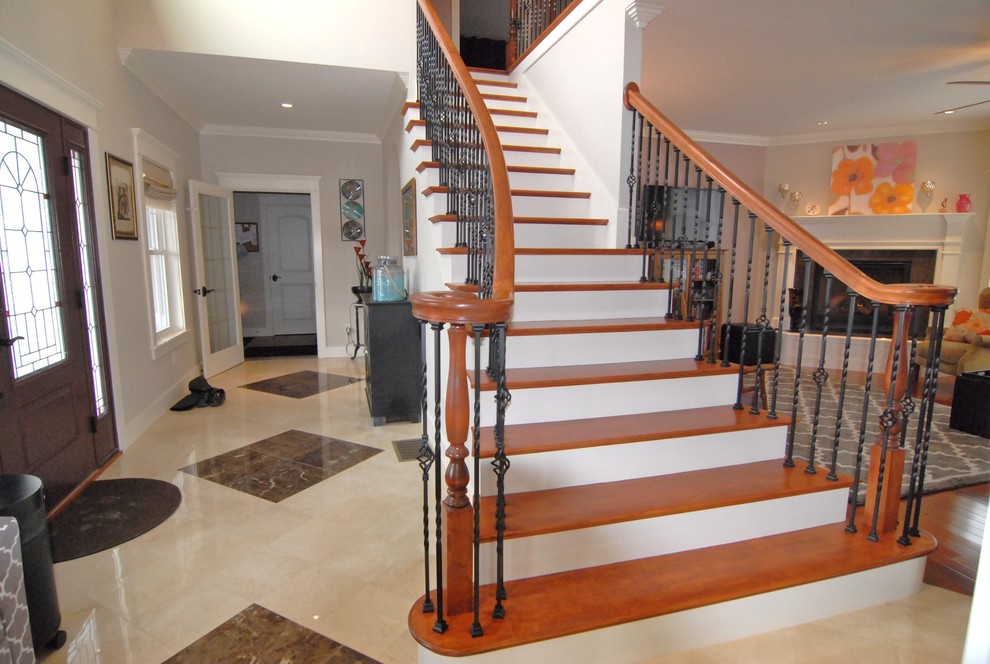Design ideas for a traditional wood curved staircase in Portland Maine with painted wood risers.