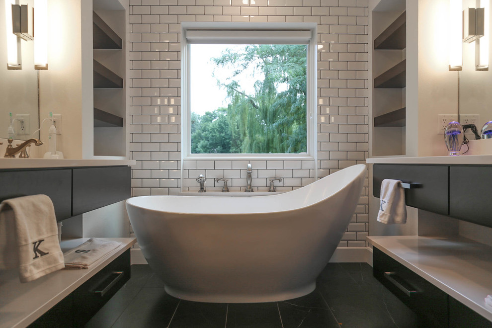 Freestanding bathtub - mid-sized transitional master white tile and subway tile porcelain tile and black floor freestanding bathtub idea with flat-panel cabinets, dark wood cabinets, a two-piece toilet, white walls, an undermount sink, quartzite countertops, a hinged shower door and white countertops