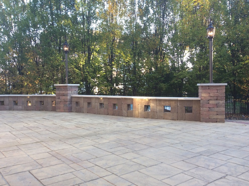 Large mediterranean backyard patio in St Louis with stamped concrete.