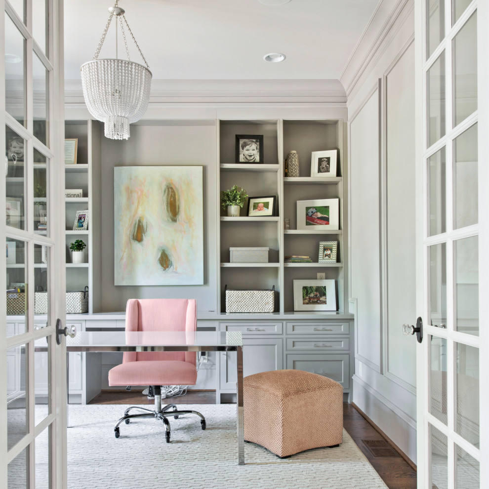 Inspiration for a traditional study room in New York with white walls, dark hardwood floors and a freestanding desk.