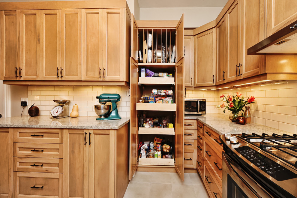 Mid-sized transitional u-shaped ceramic tile and white floor enclosed kitchen photo in Ottawa with a double-bowl sink, shaker cabinets, light wood cabinets, granite countertops, beige backsplash, ceramic backsplash, stainless steel appliances and no island