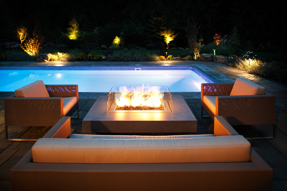 Photo of a mid-sized contemporary backyard rectangular lap pool in Seattle with concrete pavers.