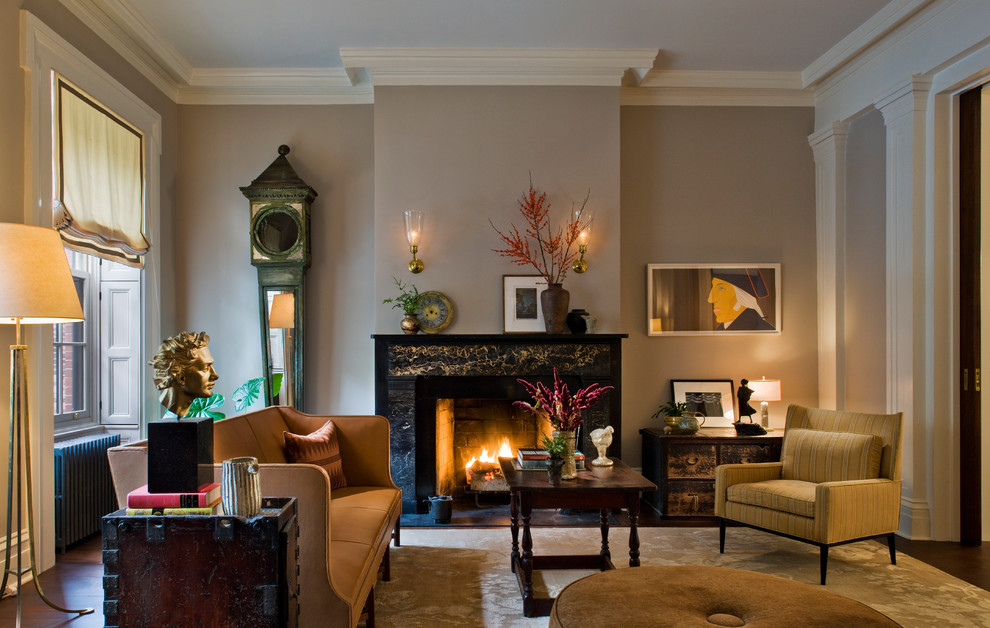 Photo of a mid-sized transitional formal enclosed living room in New York with beige walls, a standard fireplace, a stone fireplace surround, dark hardwood floors, no tv and brown floor.