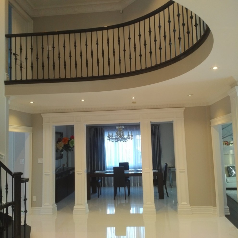 Inspiration for a mid-sized transitional beige floor foyer remodel in Toronto with beige walls