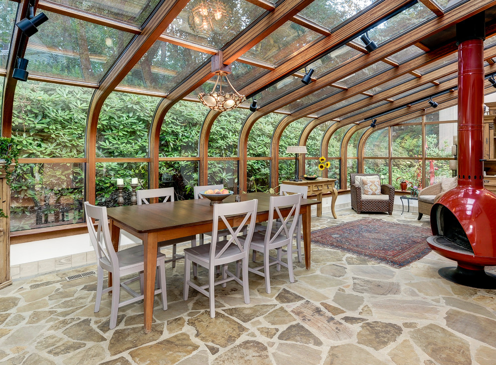 Design ideas for a country sunroom in Other with a wood stove.