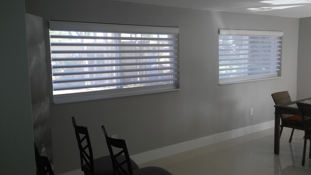 Example of a mid-sized transitional beige floor dining room design in Miami with gray walls