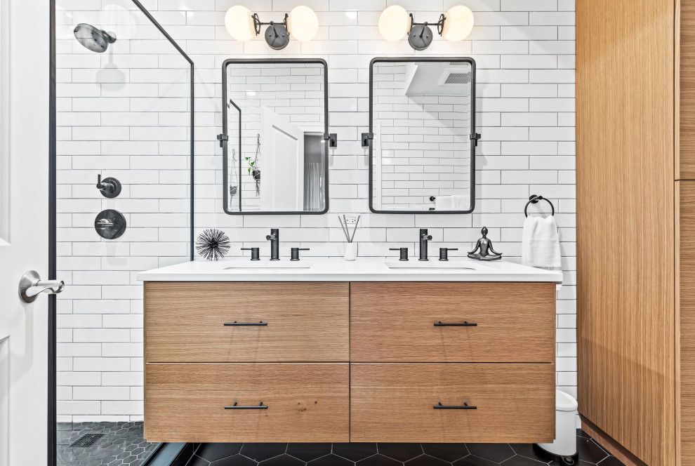 Photo of a mid-sized contemporary master wet room bathroom in Chicago with flat-panel cabinets, medium wood cabinets, a one-piece toilet, white tile, white walls, an undermount sink, engineered quartz benchtops, black floor, a hinged shower door, white benchtops, a double vanity and a built-in vanity.