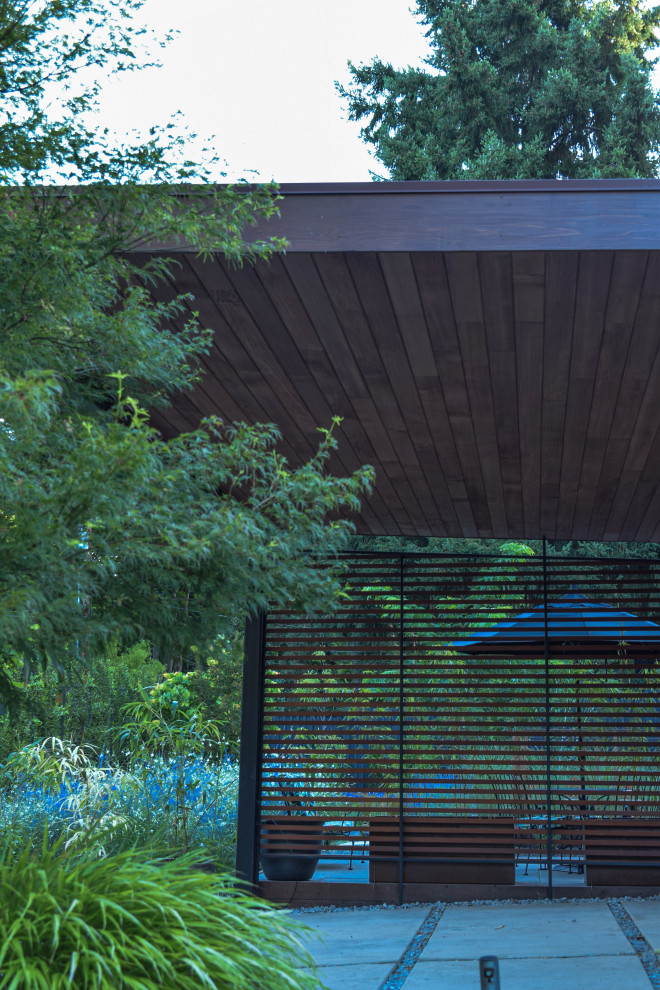 Design ideas for a medium sized modern front driveway full sun pergola for summer in Portland.