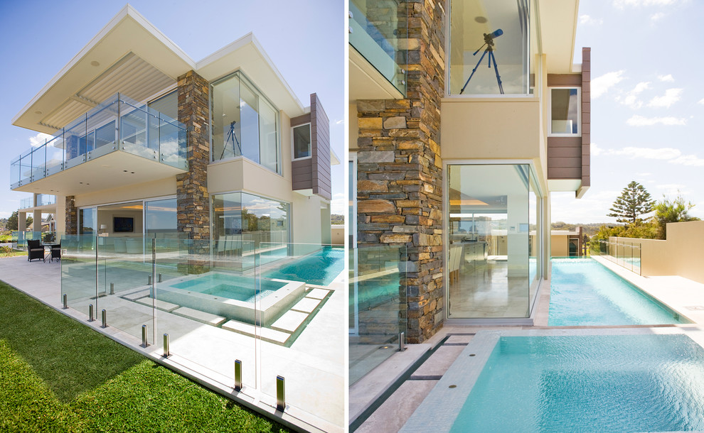 This is an example of a large contemporary side yard rectangular lap pool in Sydney with a hot tub and tile.