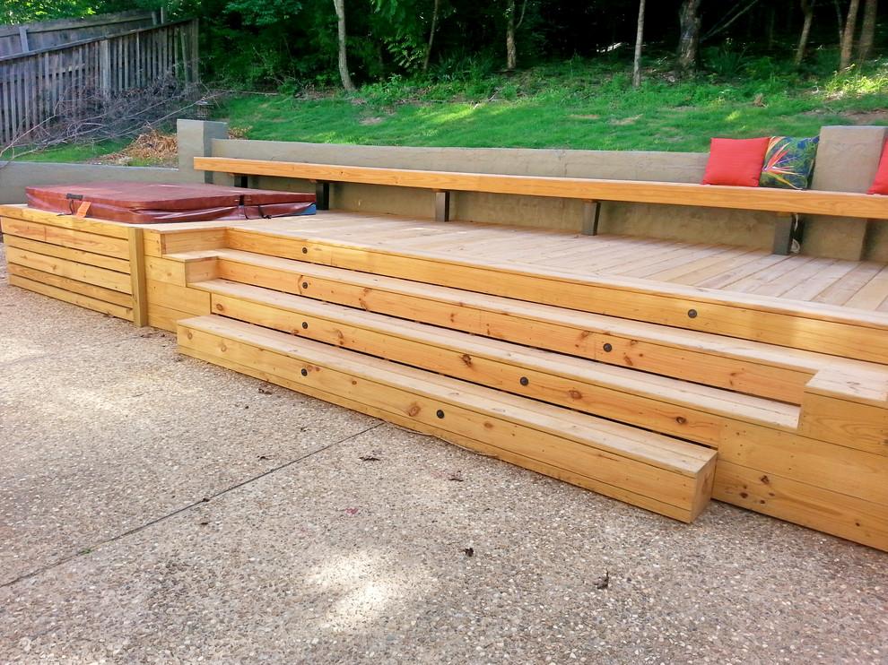 Example of a large backyard deck design with a pergola