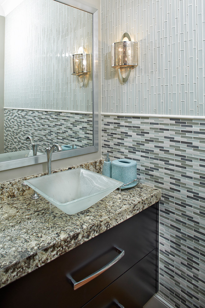 Example of a transitional 3/4 glass sheet bathroom design with flat-panel cabinets, dark wood cabinets, a vessel sink and granite countertops