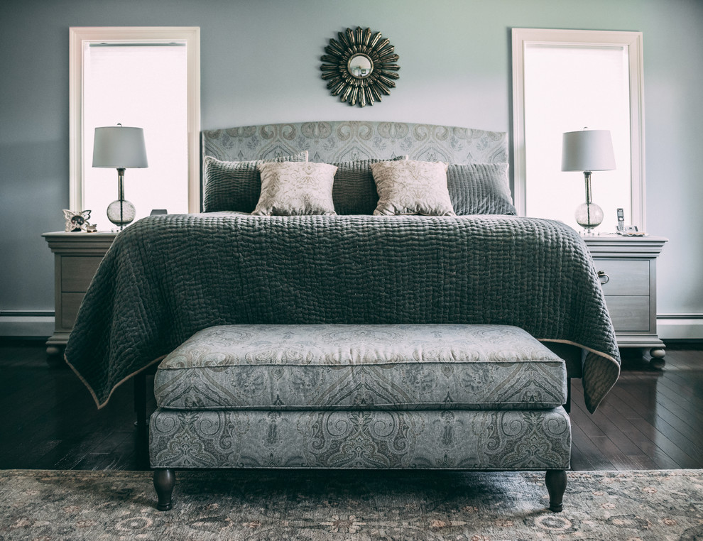 Example of a transitional master brown floor and dark wood floor bedroom design in New York with blue walls