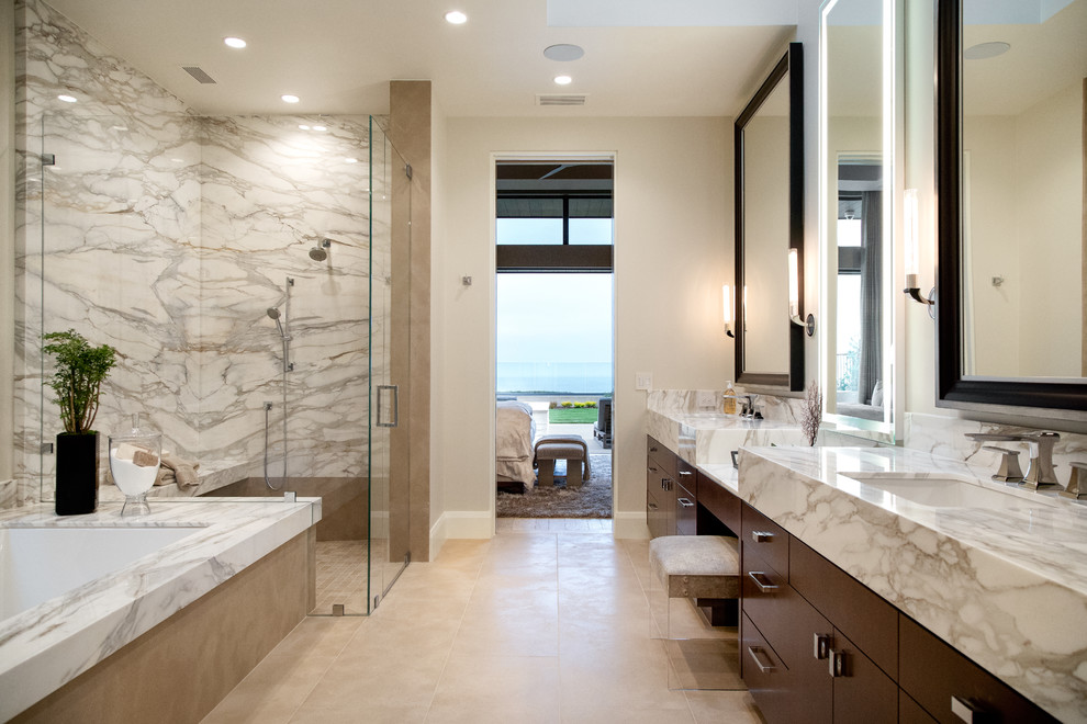 Walk-in shower - contemporary master multicolored tile and marble tile beige floor walk-in shower idea in Orange County with flat-panel cabinets, dark wood cabinets, an undermount tub, beige walls, an undermount sink, marble countertops, a hinged shower door and multicolored countertops