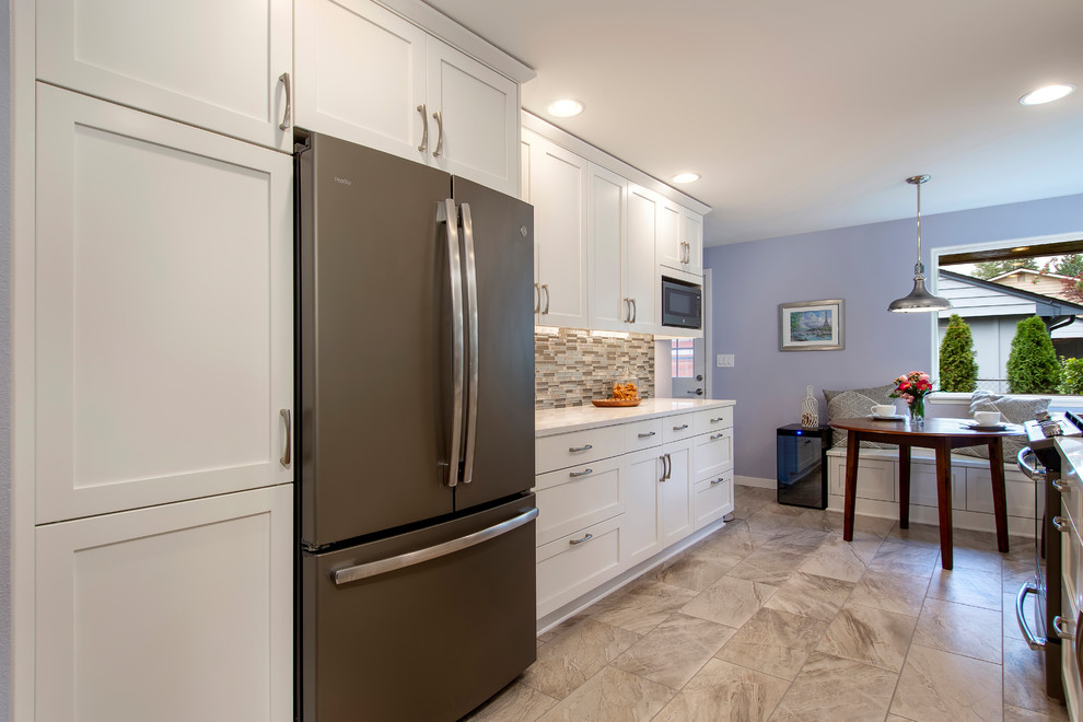 Example of a transitional porcelain tile and multicolored floor eat-in kitchen design in Seattle with an undermount sink, shaker cabinets, white cabinets, quartz countertops, multicolored backsplash, glass tile backsplash, no island and white countertops