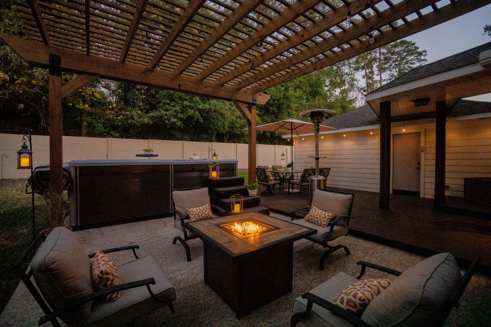 Inspiration for a small modern back patio in Houston with decking and a pergola.