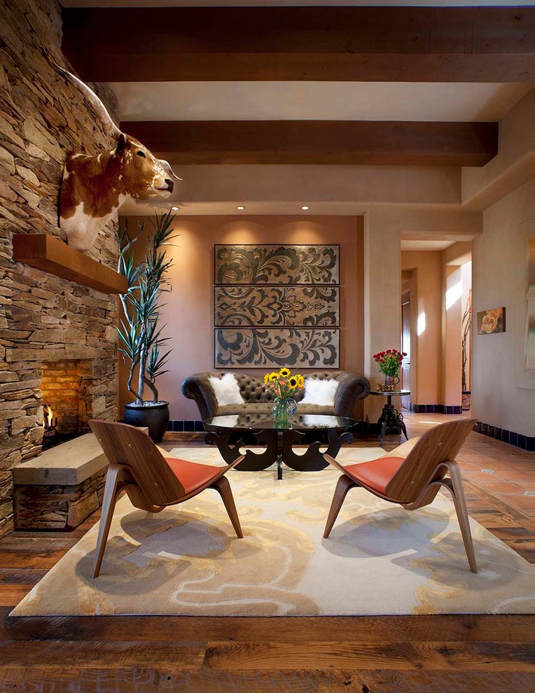 Inspiration for a mid-sized contemporary living room in Phoenix with orange walls, a standard fireplace and a stone fireplace surround.