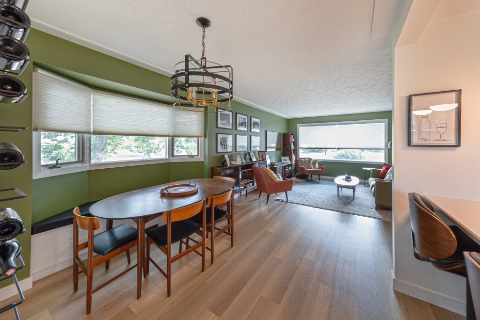 Inspiration for a mid-sized midcentury kitchen/dining combo in Edmonton with green walls, vinyl floors and brown floor.