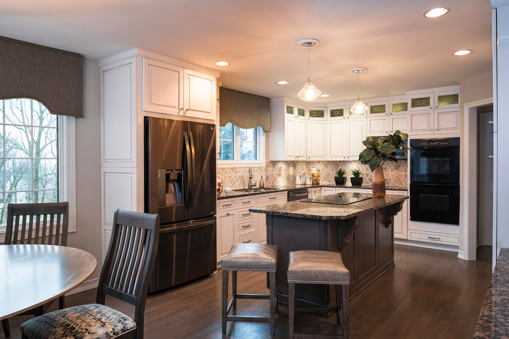 Mid-sized transitional dark wood floor and gray floor eat-in kitchen photo in Cincinnati with a double-bowl sink, glass-front cabinets, white cabinets, granite countertops, beige backsplash, mosaic tile backsplash, stainless steel appliances and an island