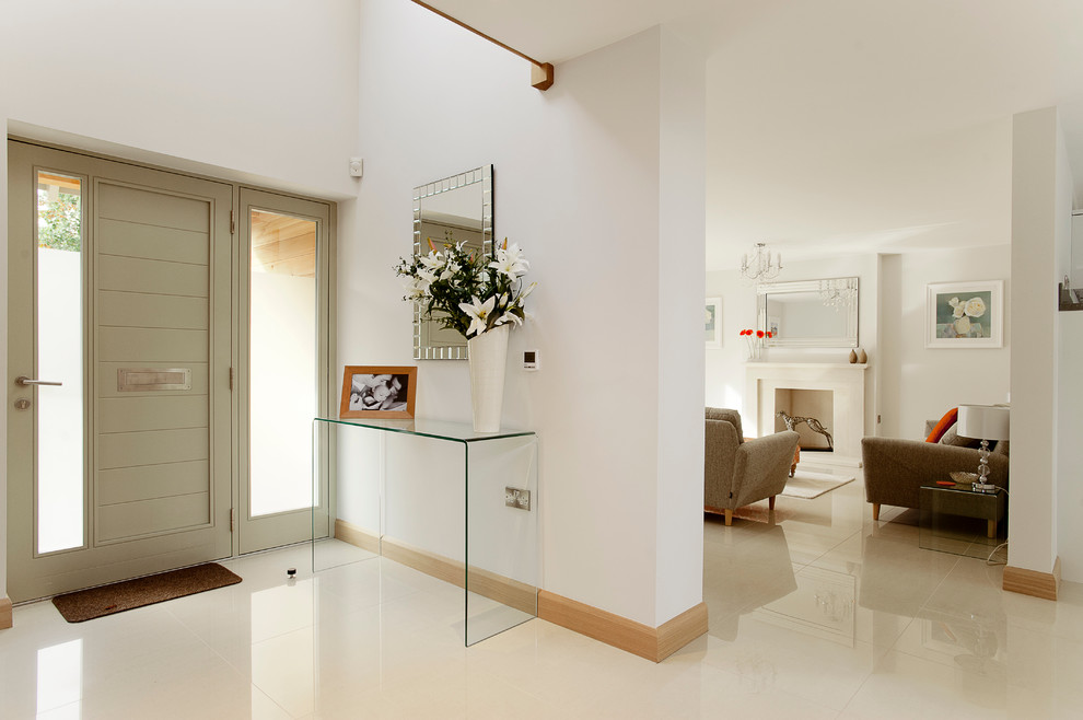 Design ideas for a contemporary entryway in Dorset with white walls and white floor.