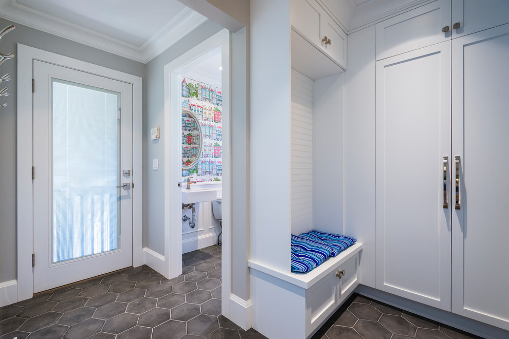 This is an example of a small transitional mudroom in Other with grey walls, porcelain floors, a single front door, a white front door and grey floor.
