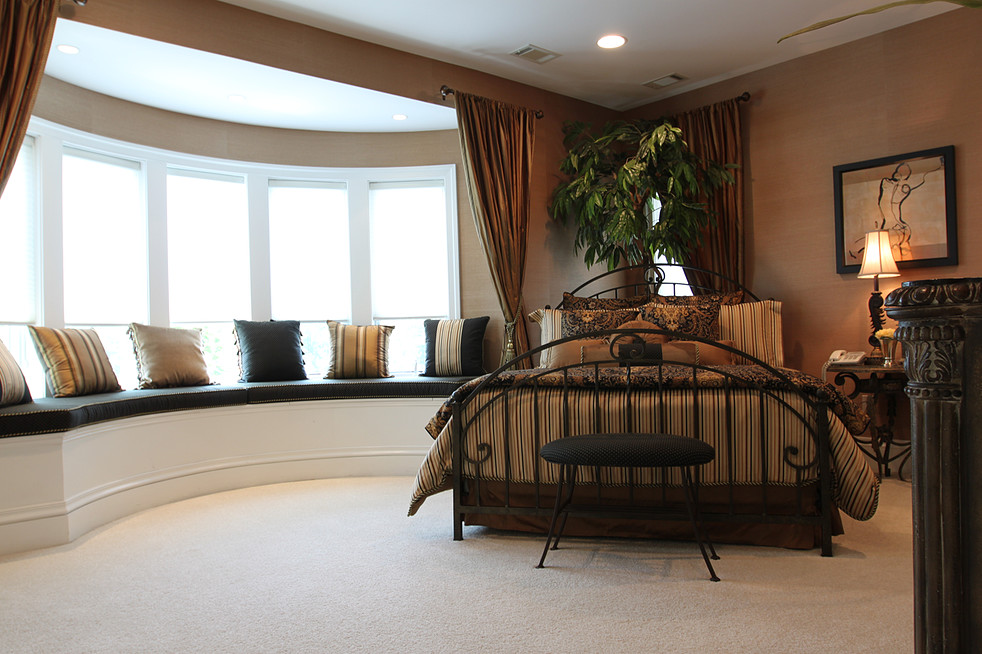 Expansive contemporary guest bedroom in DC Metro with brown walls, carpet, a ribbon fireplace and white floor.