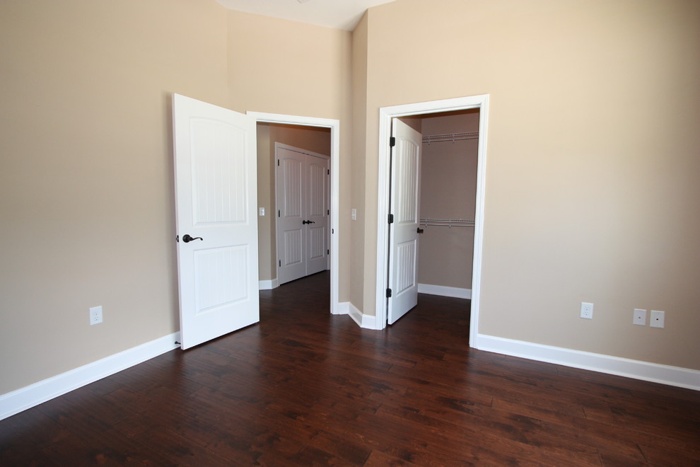 Design ideas for a mid-sized arts and crafts guest bedroom in Jacksonville with beige walls, dark hardwood floors and no fireplace.