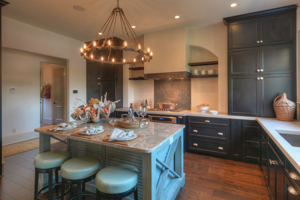 Inspiration for a timeless light wood floor eat-in kitchen remodel in Jacksonville with an undermount sink, recessed-panel cabinets, black cabinets, stainless steel appliances and an island